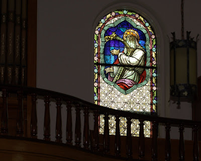Stained glass window of King David playing a harp