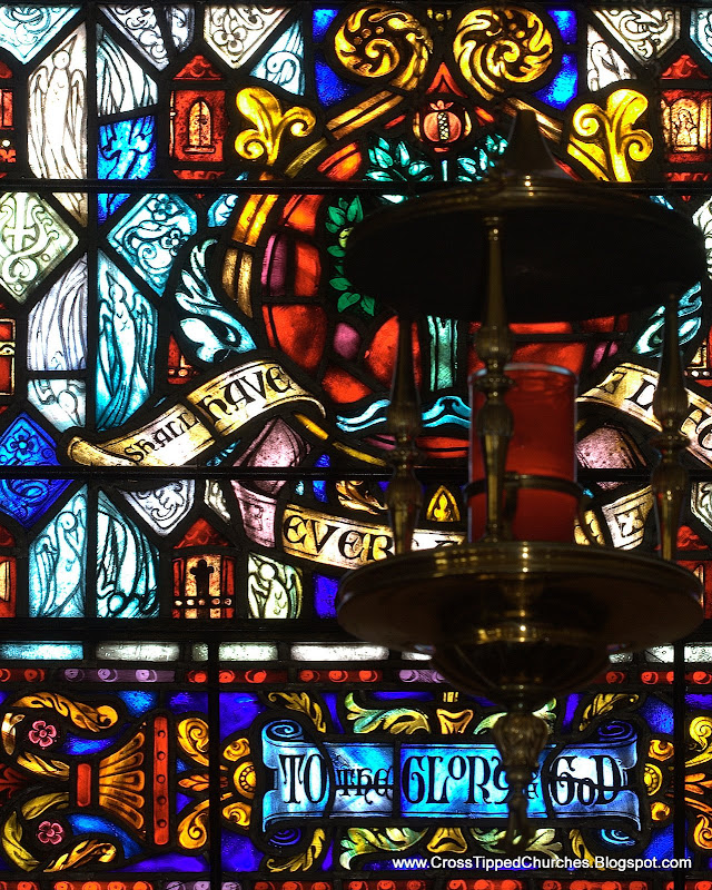 Eternity Candle with stained glass window background with the words To The Glory of God.