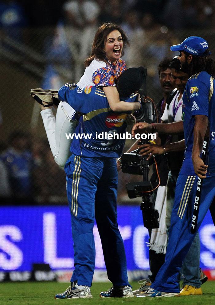 Nita Ambani celebrates as she is lifted by Harbhajan Singh. Nita Ambani celebrates as she is lifted by Harbhajan Singh.