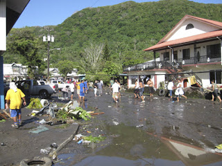 Sept. 29: People walk among a scene of devastation following a powerful earthquake in Pago Pago village, on American Samoa. The quake in the South Pacific hurled massive tsunami waves at the shores of Samoa and American Samoa, flattening villages and sweeping cars and people back out to sea while leaving scores dead and dozens missing.Source: AP2009