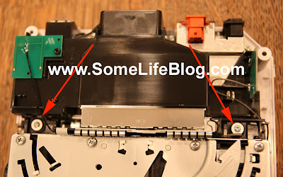 Wii DVD Drive Replacement: There are 4 small Phillips screws that anchor the DVD drive into the Nintendo Wii console. First, remove the two highlighted in the image below found towards the rear of the case where you see arrows in the picture below. Wii DVD Drive Replacement: There are 4 small Phillips screws that anchor the DVD drive into the Nintendo Wii console. First, remove the two highlighted in the image below found towards the rear of the case where you see arrows in the picture below.