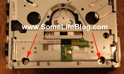 Wii DVD Drive Replacement: Next up are two more difficult screws. These ones are found towards the front of the DVD drive on your Wii Console, recessed into two holes about 1/2 inch deep. If you have a small Phillip screwdriver with a magnetic tip, this is optimal for this task. Alternatively, you can remove them while the Wii is upside down so the screws do not fall down inside the Wii's DVD drive. Wii DVD Drive Replacement: Next up are two more difficult screws. These ones are found towards the front of the DVD drive on your Wii Console, recessed into two holes about 1/2 inch deep. If you have a small Phillip screwdriver with a magnetic tip, this is optimal for this task. Alternatively, you can remove them while the Wii is upside down so the screws do not fall down inside the Wii's DVD drive.