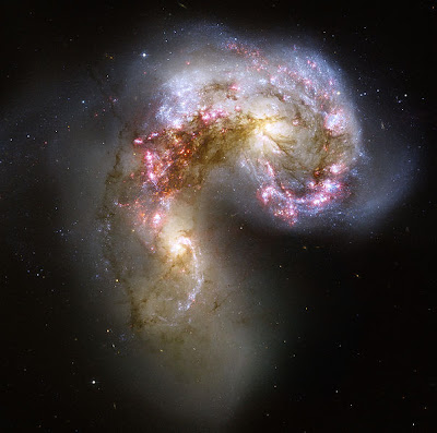 Bodies of stars wrestling beyond the fields we know. - The Antennae Galaxies, by NASA, ESA, and the Hubble Heritage Team - public domain. Bodies of stars wrestling beyond the fields we know. - The Antennae Galaxies, by NASA, ESA, and the Hubble Heritage Team - public domain.