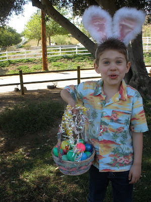 cute kid with easter basket and bunny ears