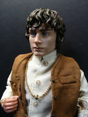 elijah wood frodo baggins. Frodo has a coat over his vest