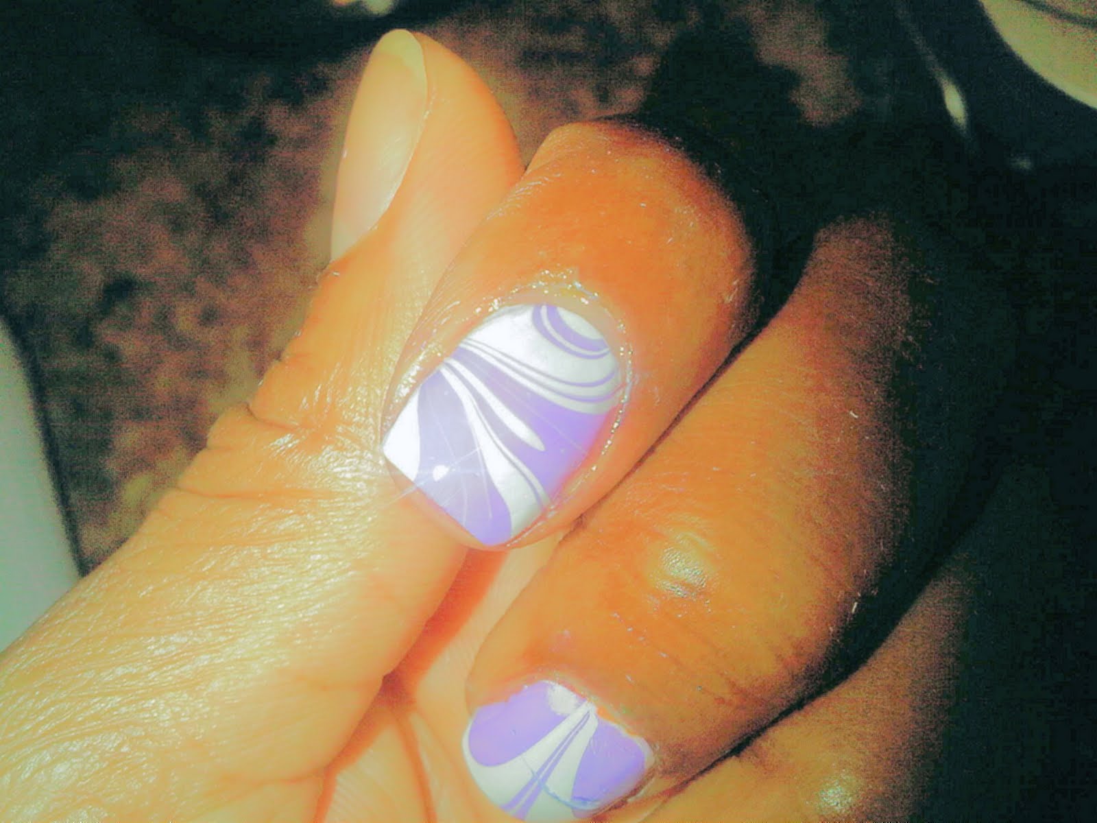 Its an nail design effect done with nail polish and a bowl of water Its an nail design effect done with nail polish and a bowl of water