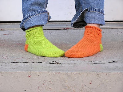 green and orange socks, toes together