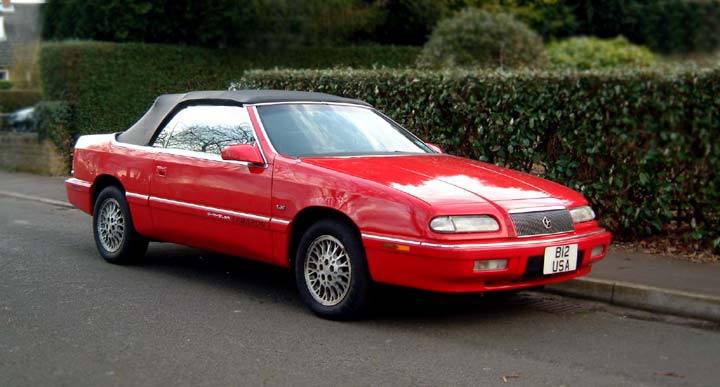 A 1995 cherry red, black top, Chrysler Lebaron convertible A 1995 cherry red, black top, Chrysler Lebaron convertible