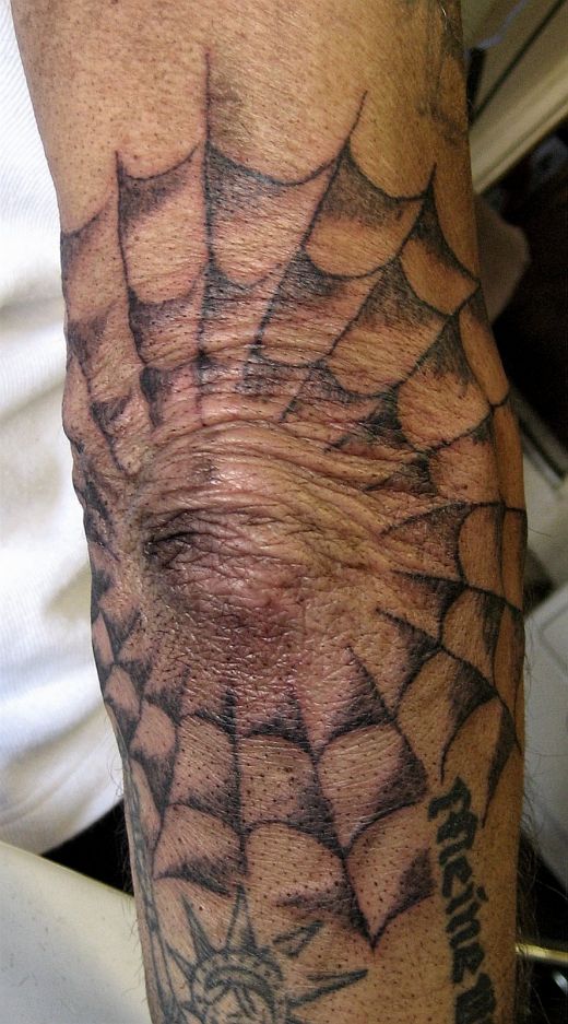 christian sleeve tattoo spider web tattoo on the elbow. Tattoo Bans