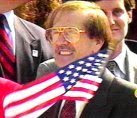 SONNY BONO HOLDING AN AMERICAN FLAG