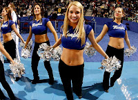 Four University of Memphis dance team members with pom poms performing at an event.