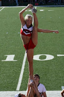 SMU cheerleader does the splits holding leg above her head.