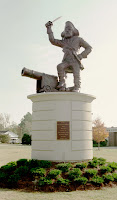 Pirate mascot statue with cannon on ECU campus.