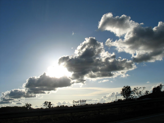 scene of sun, clouds and earth silhouette