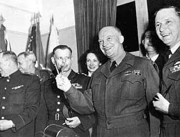 Gen. Dwight D. Eisenhower makes a V for victory sign with two pens used to sign Germany's unconditional surrender at Reims, France, on May 7, 1945. From left are Russian Gen. Ivan Susloparoff; Lt. Gen. Sir F.E. Morgan; Lt. Gen. Walter Bedell Smith; Eisenhower's secretary, Kay Summersby; Eisenhower; Capt Harry C. Butcher; and Sir Arthur Tedder. (AP Photo)