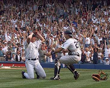New York Yankees pitcher David Cone falls to his knees after the last out is recorded in his perfect game against the Montreal Expos on July 18, 1999. Yankee catcher Joe Girardi rushes out to congratulate Cone. (AP Photo/Jeff Zelevansky)