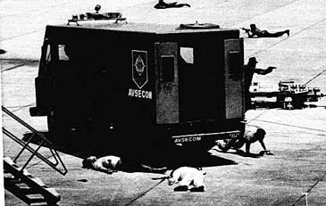 The body of Philippine opposition leader Benigno S. Aquino Jr. lies at center and his assassin's body is at left on Aug. 21, 1983, at Manila International Airport. (AP Photo)