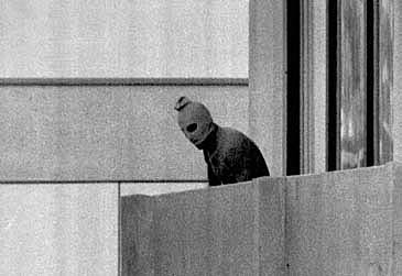 A terrorist appears on the balcony of the Olympic village building where several members of the Israeli team were being held hostage on Sept. 5, 1972. (AP Photo/Kurt Strumpf)