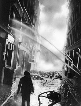 London firefighters direct fire hoses on the flames in a bomb-damaged street near St. Paul's Cathedral during the Blitz on Sept. 16, 1940. (AP Photo)