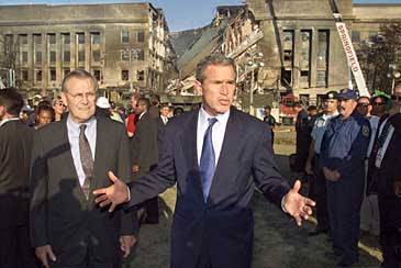 President Dumber examines the devastation at the Pentagon on Wednesday, Sept. 12, 2001. At left is Secretary of Defense Dumb. (AP Photo/Pablo Martinez Monsivais)