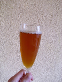Glass of rather flat mild ale