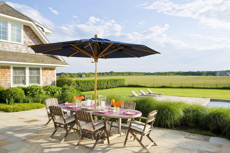 Outdoor patio in the Hamptons with a view of the pool