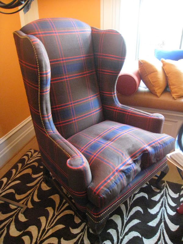 Plaid wingback armchair with nail head trim