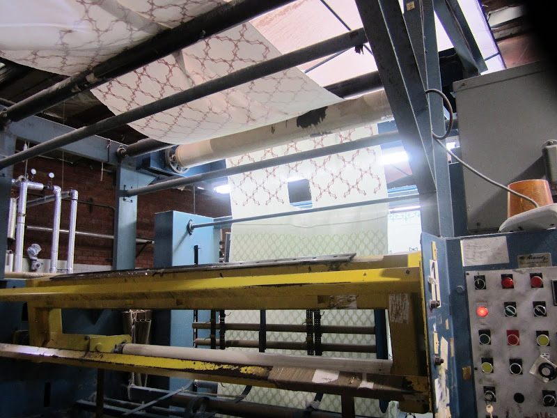 Nbaynadamas fabric on a framing machine in a print house