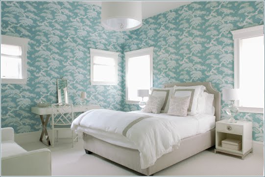 Bedroom with floor to ceiling blue toile wallpaper, windows, a white nightstand, upholstered headboard and an oval pendant light