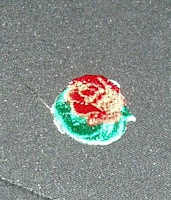 A rose lapel sticker given to me at Tournament House.
