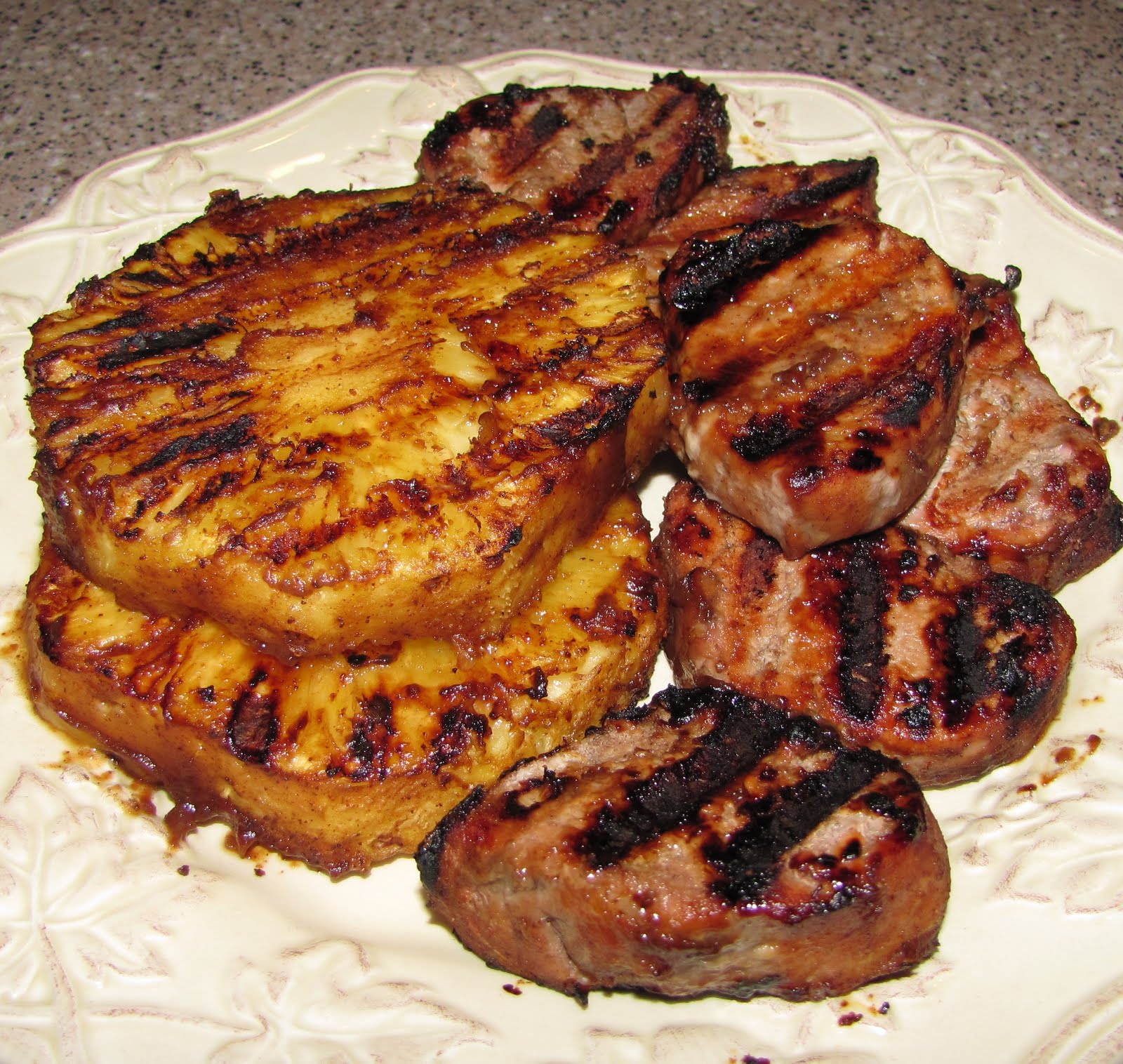 Family American Style Grilled pork tenderloin with grilled pineapple.