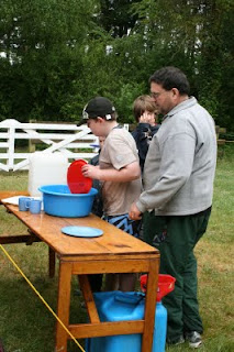 Please- remind me again - we could NOT have a dishwasher out here - because . . . . Scout washing the dishes