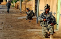 Soldiers assigned to Company B, 2-502nd Infantry Regiment, pull security on a street during a raid in Jabella, Iraq, May 2. (U.S. Army photo by Spc. Amanda McBride)