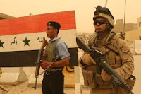 Petty Officer 2nd Class Giovanni Lozano, a corpsman with 1st Battalion, 9th Marines, patrols with an Iraqi police officer through the market area of Ramadi June 9. The Iraqi police are continuing to make tremendous progress since the area became stable.