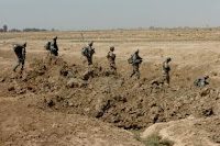 Soldiers with Grim Troop, 2nd Squadron, 3d Armored Cavalry Regiment and Soldiers with the 5th Iraqi Army Divisions, head out toward the next objective during and air assault mission, July 25, 2008. The air assault mission was geared toward forcing insurgents out of the village of al Fatah Miaya. Once the insurgents were removed from the village the villagers could return to rebuil their lives. ID: 106498; Date Taken: July 31st, 2008; Location: Tikrit, IQ; Photographer: Sgt. Kyle Richardson, 11th Public Affairs Detachment