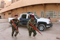 Sgt. Ammar Muhammed Hammed and Warrant Officer Hashim Fakri Hasan practice maintaining a personal security detail. The top American commander in Iraq said the U.S. will continue to aid the nation's improving security situation.