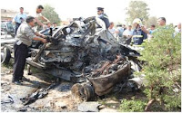 Iraqi police inspect the wreckage of the police vehicle destroyed by the suicide vehicle-borne improvised explosive device driven by a teenage boy in Kirkuk last month.