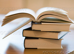 [open-book-on-stack-of-closed-books-~-200363851-001.jpg]