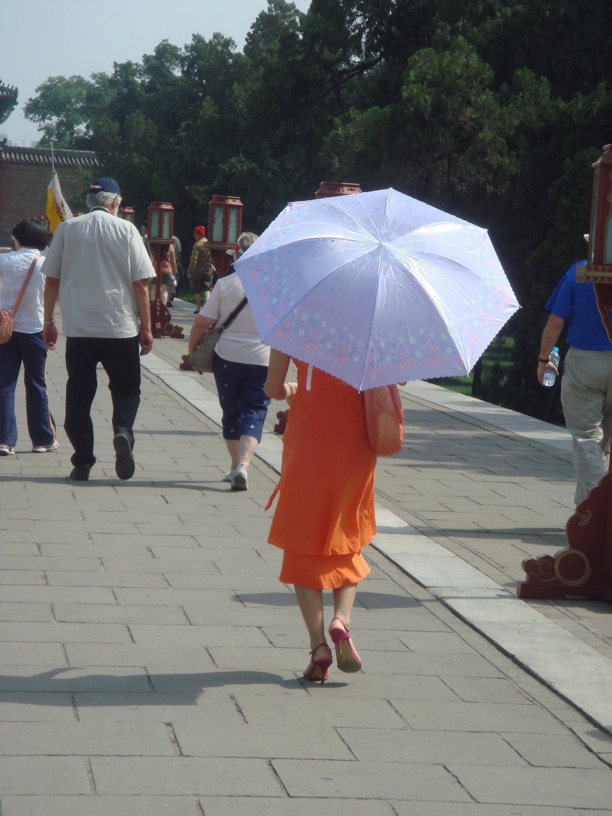 [woman+in+orange+dress+and+umbrella.jpg]