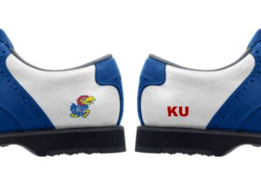 Blue KU golf shoes with logos of Big Jay the Jayhawk and red letters reading KU on a white background on lady's footwear with blue trim and black soles.