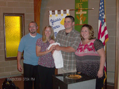 baby Logan w/mom (Amy) dad (Jason) & held by godparents Sarah & Bob.