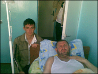 Ion Butmalai in hospital bed with son Ion