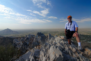Gene Hanson on the summit of Piestewa Peak, with Black Mountain in the distance Gene Hanson on the summit of Piestewa Peak, with Black Mountain in the distance