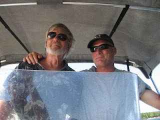 Eric at the helm of his skiff with Capt. John Eric at the helm of his skiff with Capt. John