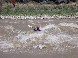 Aspen Kayak Academy student in the standing wave at 'Little D' rapids in Westwater Canyon Aspen Kayak Academy student in the standing wave at 'Little D' rapids in Westwater Canyon