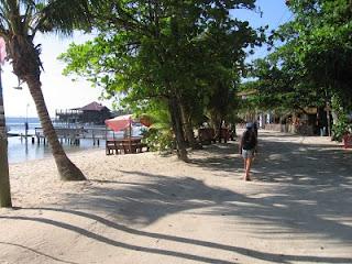 Nan walking the sandy main road in Roatan's West End Nan walking the sandy main road in Roatan's West End