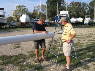 John Kretschmer and John Simonton examine Whispering Jesse's freshly painted mast John Kretschmer and John Simonton examine Whispering Jesse's freshly painted mast