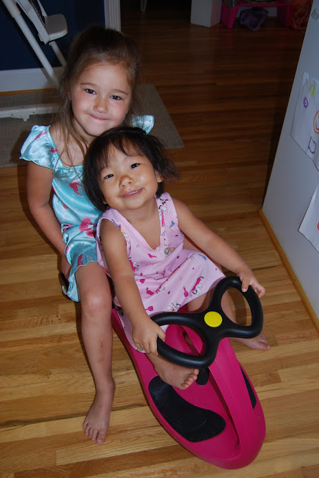 Sisters riding around the house