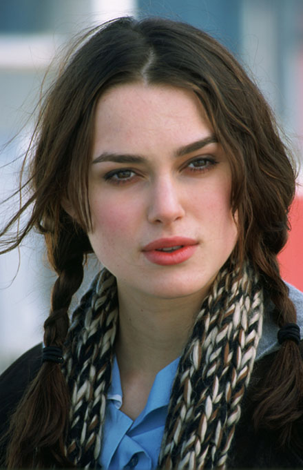 Keira Knightley back in 2004 with a dark wavy hairstyle with bangs.