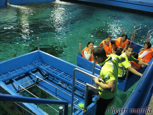 The Manila Ocean Park's glass bottom boat ride. a small boat with a glass The Manila Ocean Park's glass bottom boat ride. a small boat with a glass